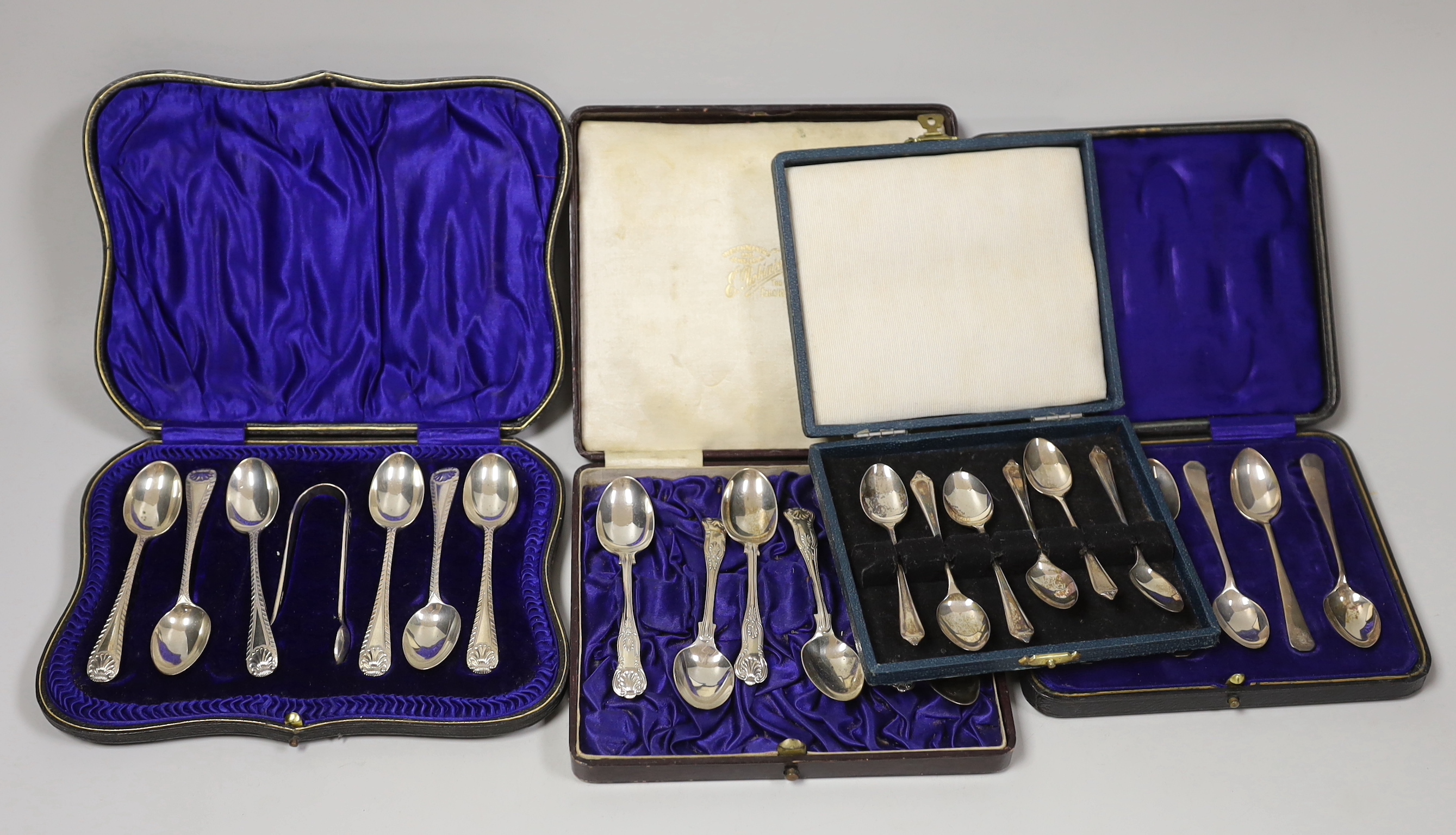 Three assorted cased sets of six silver tea or coffee spoons, one with tongs and other incomplete set.